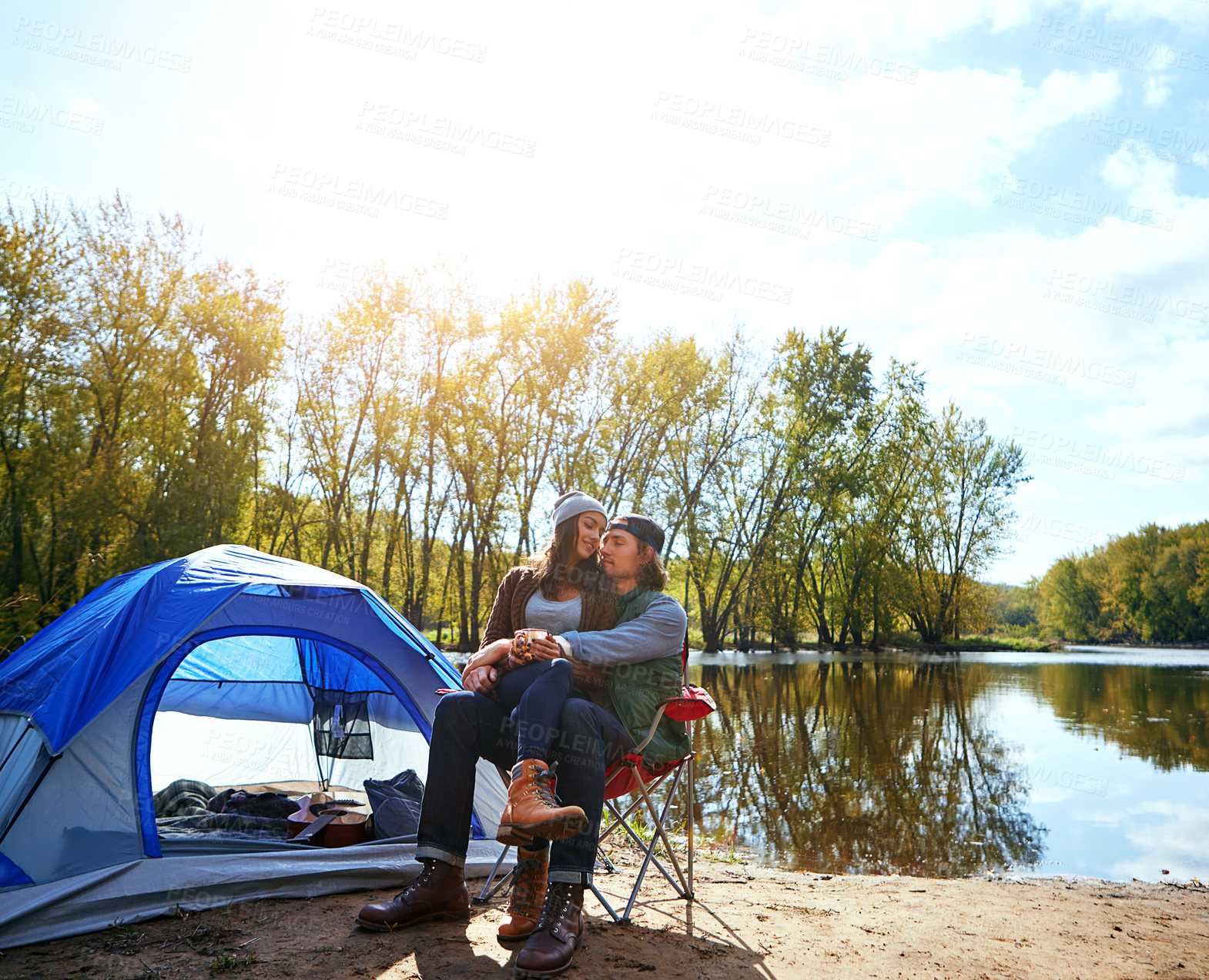 Buy stock photo Shot of an adventurous young couple at their campsite