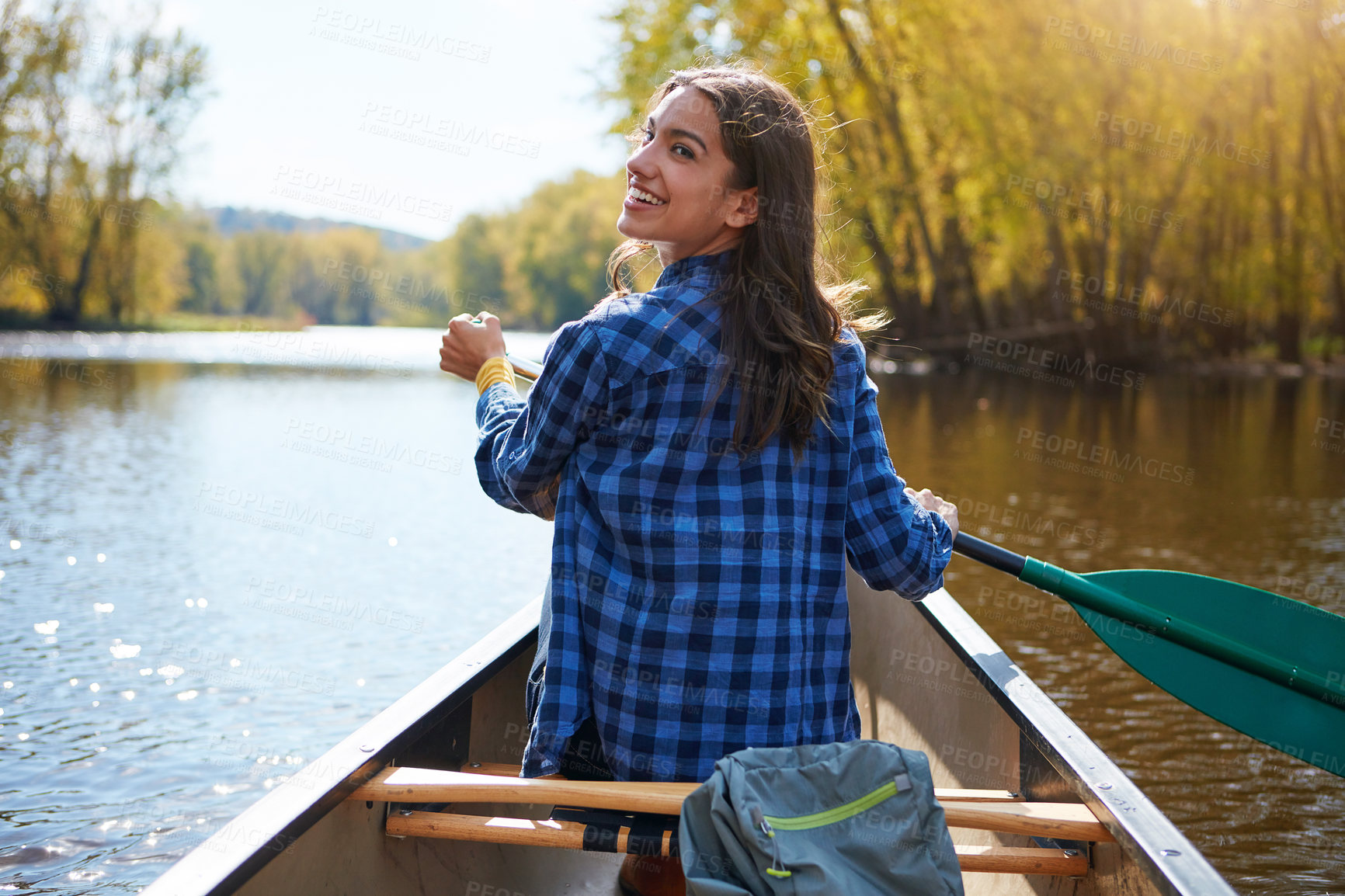 Buy stock photo Shot of a young woman going for a canoe ride on the lake