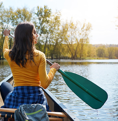 Buy stock photo Woman, back and canoeing in nature on lake, wellness hobby and backpack for supplies with paddle for rowing. Vacation, relax and explore exercise on travel holiday, canoe boat and trees on river bank