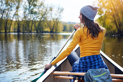 Buy stock photo Woman, back and canoeing in forest on water, wellness hobby and backpack for supplies with paddle for rowing. Vacation, relax and explore exercise on travel holiday, canoe boat and trees on river