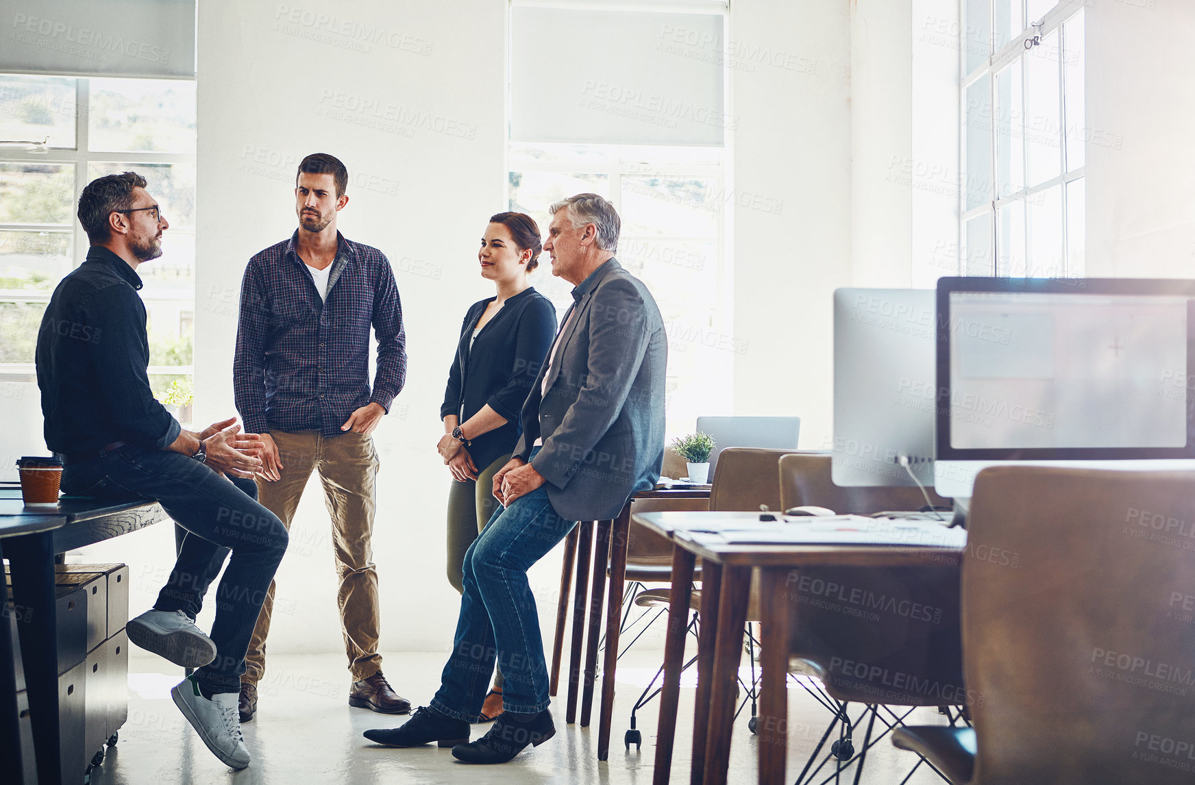 Buy stock photo Shot of a group of designers having a discussion at work