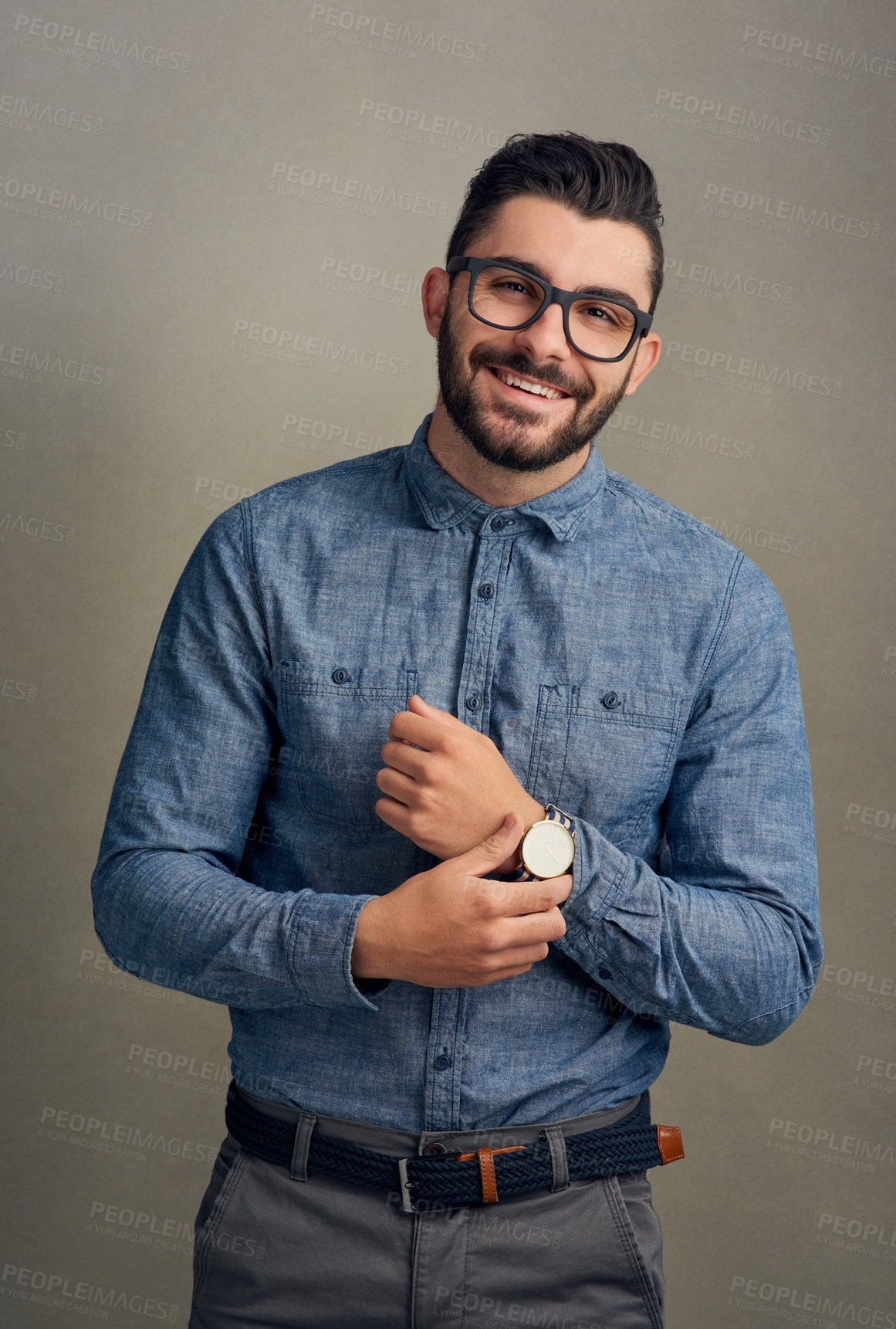 Buy stock photo Studio portrait of a handsome young man posing against a grey background