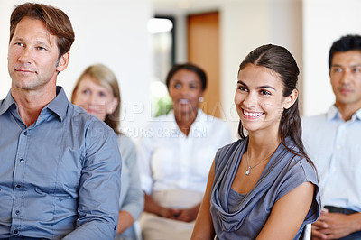 Buy stock photo Shot of a group of coworkers watching a work seminar