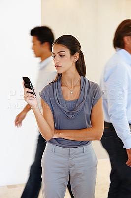 Buy stock photo Woman, smartphone and checking in busy office with communication in workplace. Female person, mobile and work with technology for reading or research with determination for profession in business