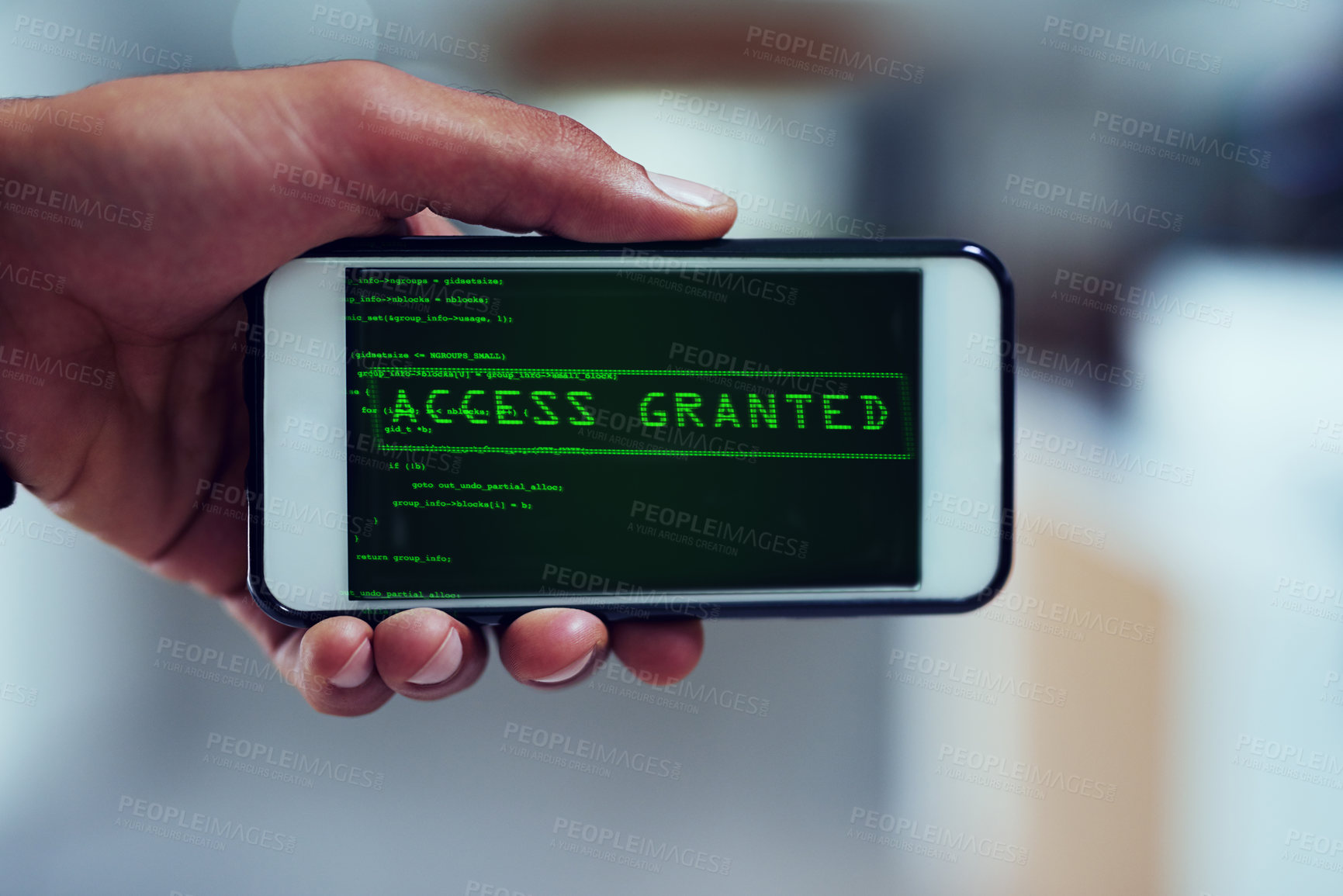 Buy stock photo Shot of an unidentifiable man using a smartphone to hack into a computer network