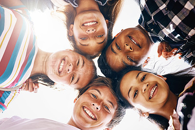 Buy stock photo Low angle portrait of a group of diverse schoolchildren standing in a huddle