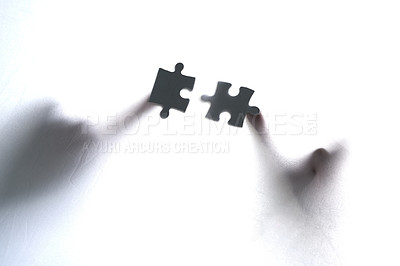 Hands, puzzle or people in studio for problem solving, collaboration and teamwork solution on white background. Jigsaw, planning or shadow art with figures for conspiracy, understanding or philosophy