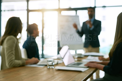Buy stock photo Shot of a group of corporate businesspeople meeting in the boardroom