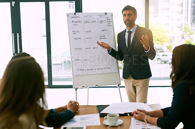 Buy stock photo Shot of a group of corporate businesspeople meeting in the boardroom