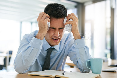 Buy stock photo Cropped shot of a young businessman looking frustrated while sitting at his desk