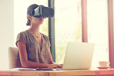 Buy stock photo Shot of a young businesswoman wearing a VR headset while working in an office
