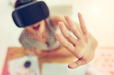 Buy stock photo High angle shot of a young businesswoman wearing a VR headset while working in an office