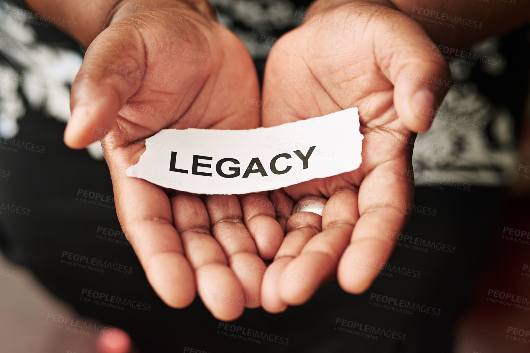 Buy stock photo Cropped shot of a woman holding a piece of paper with the word “legacy” on it