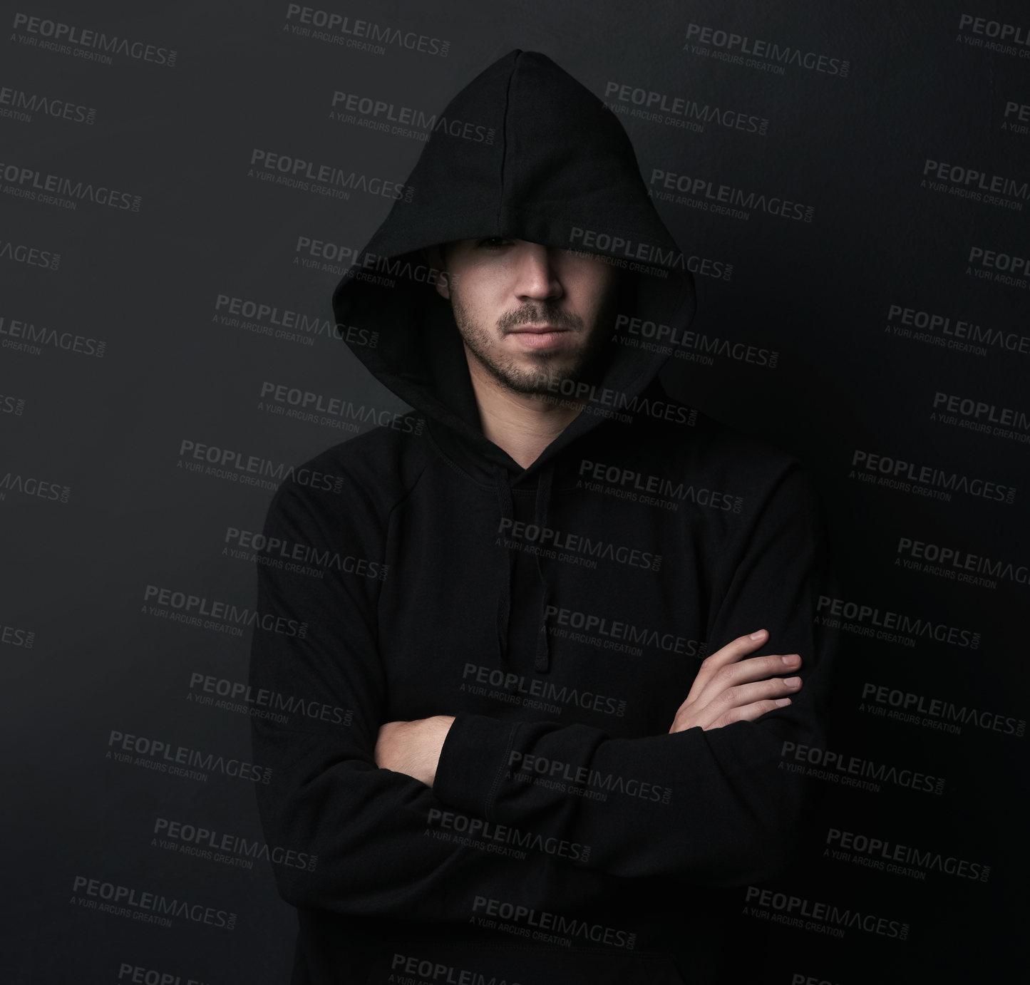 Buy stock photo Portrait of a man posing with his arms crossed against a dark background
