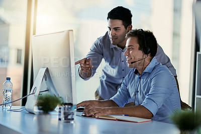 Buy stock photo Cropped shot of two call centre agents working together in an office