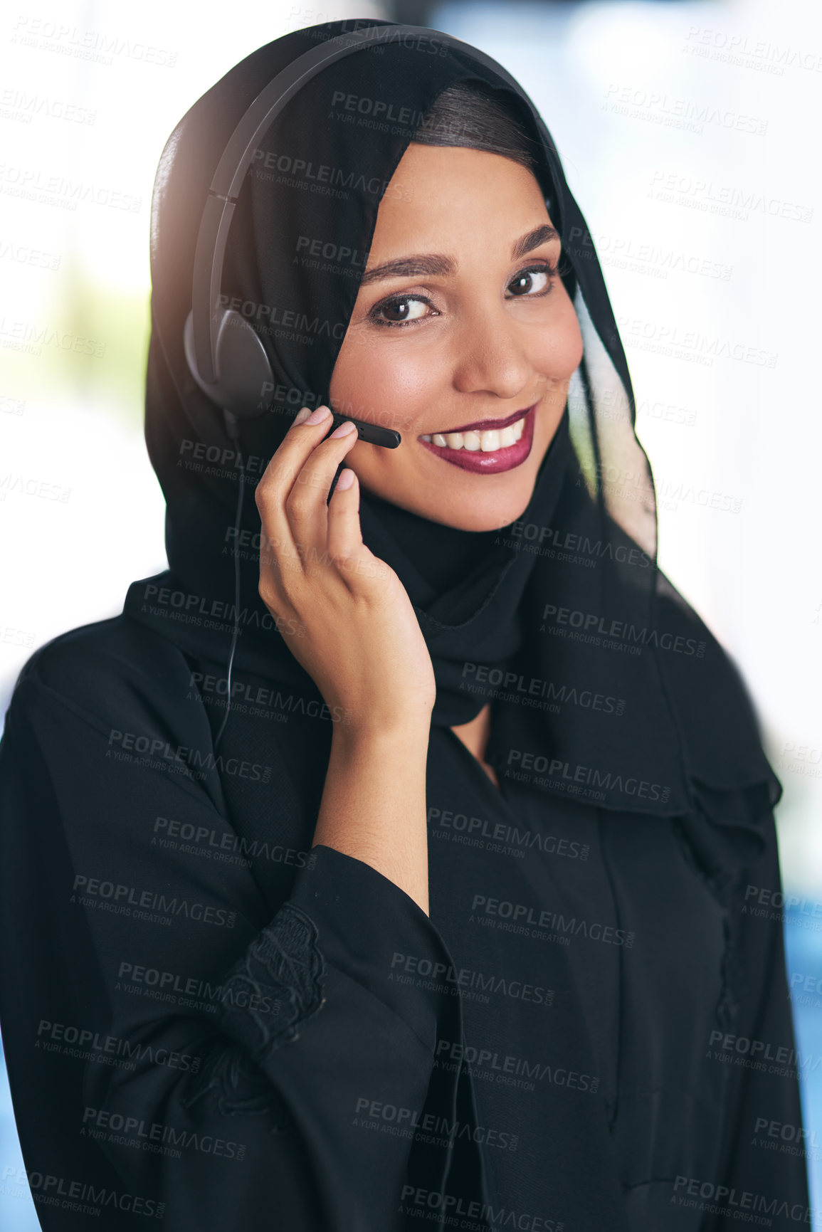 Buy stock photo Portrait of a friendly young muslim call center agent working in a modern office