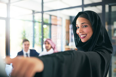 Buy stock photo Shot of a young muslim businesswoman delivering a presentation to her team at work