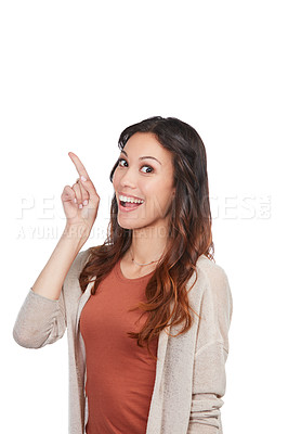 Buy stock photo Portrait of a confident young woman pointing at blank copyspace in studio