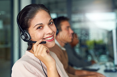 Buy stock photo Portrait of a call centre agent working in an office with her colleagues in the background