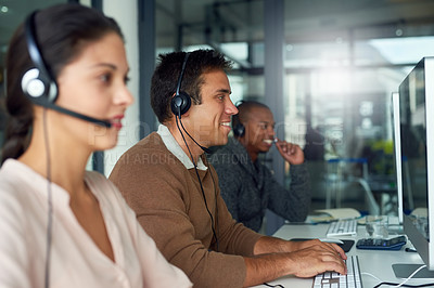Buy stock photo Shot of call centre agents working in an office