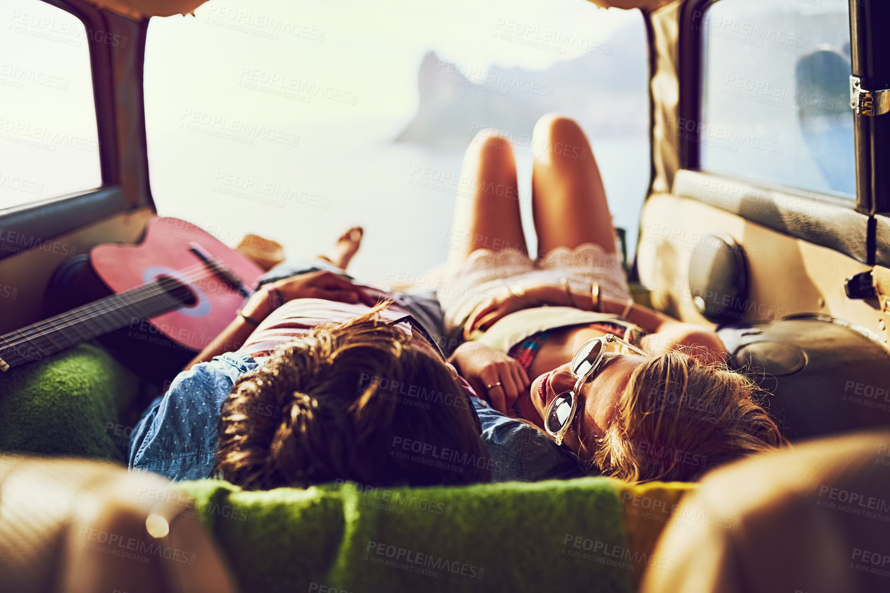 Buy stock photo Rearview shot of a young couple relaxing inside their car during a roadtrip