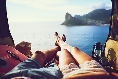 Buy stock photo Shot of an unidentifiable young couple relaxing inside their car during a roadtrip