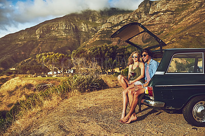 Buy stock photo Portrait of a happy young couple posing with their car on a roadtrip