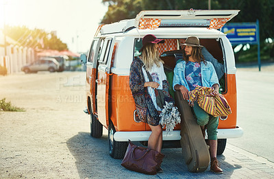 Buy stock photo Shot of a young hipster couple leaning on the back of their camper van