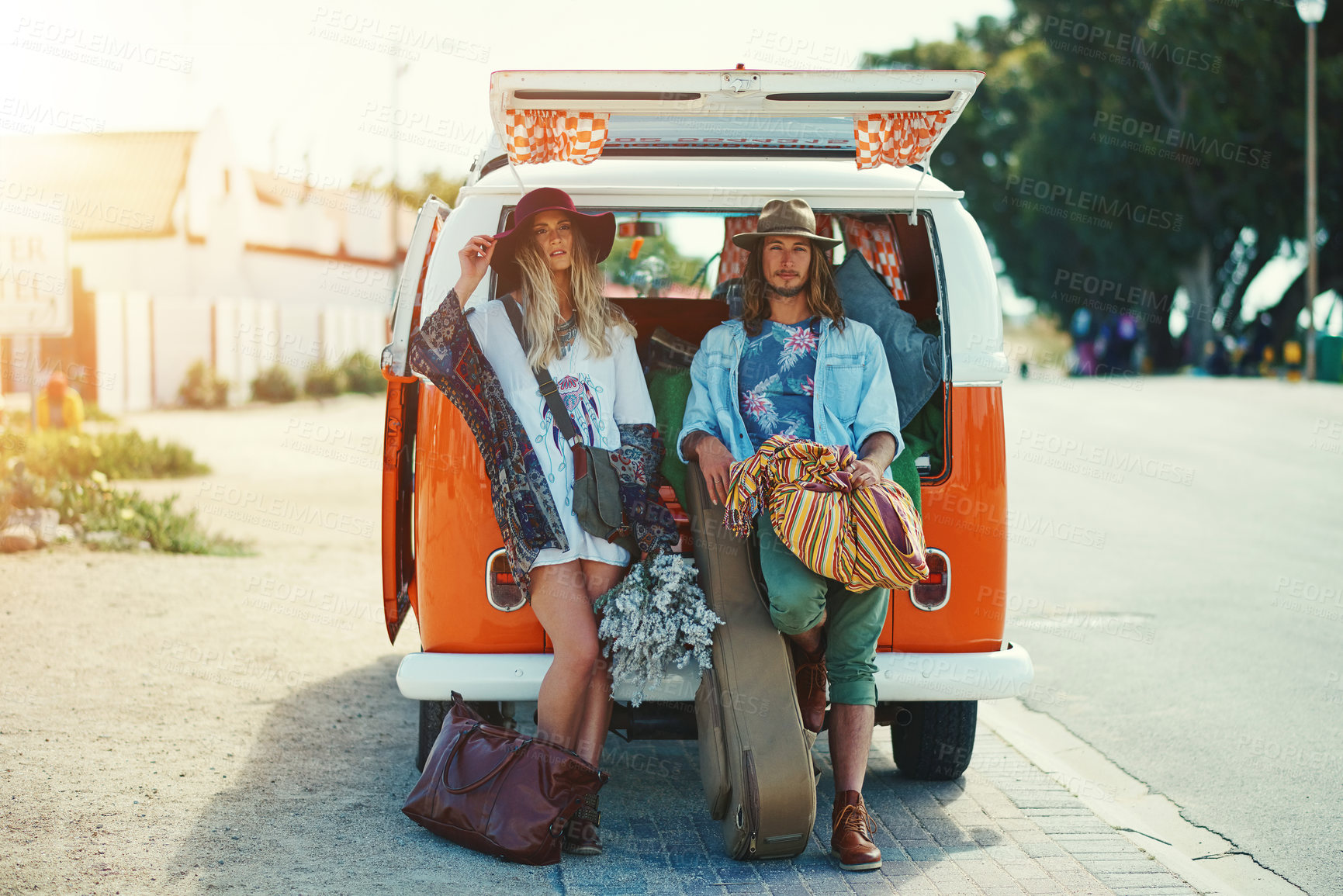 Buy stock photo Shot of a young hipster couple leaning on the back of their camper van