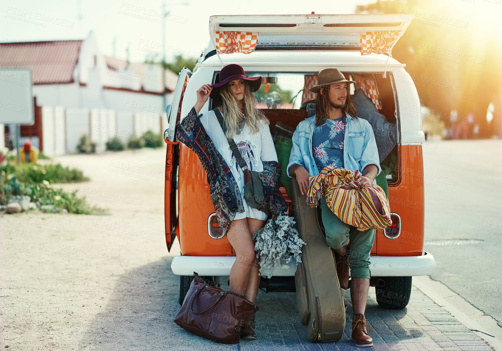 Buy stock photo Shot of a young hipster couple leaning on the back of their camper van