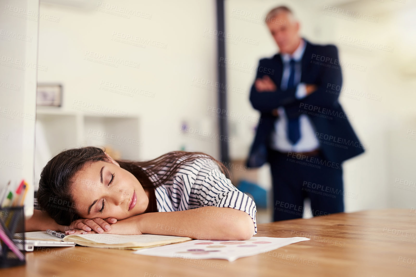 Buy stock photo Cropped shot of a businesswoman sleeping at her desk with her boss standing in the background