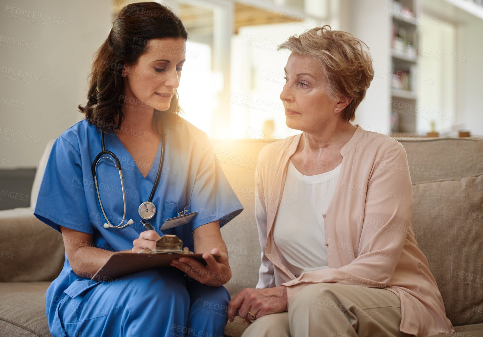 Buy stock photo Shot of a senior woman talking with a nurse in assisted living facility
