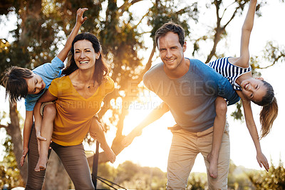 Buy stock photo Portrait of a family with two young children posing together outside