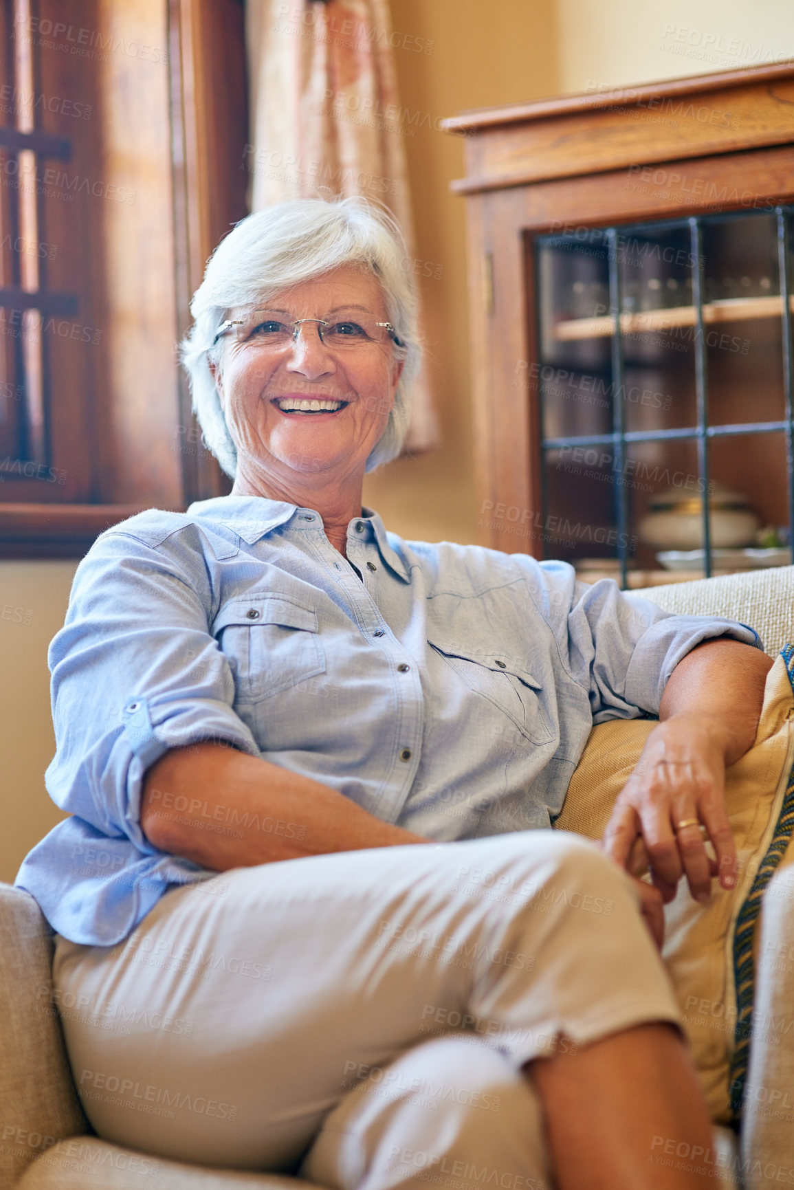 Buy stock photo Portrait of a senior woman relaxing on the sofa at home