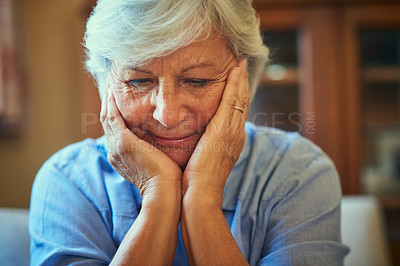 Buy stock photo Cropped shot of a senior woman looking thoughtful at home