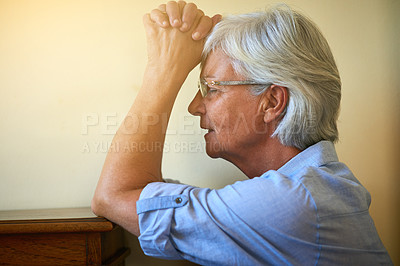 Buy stock photo Cropped shot of a senior woman with her hands clasped in prayer