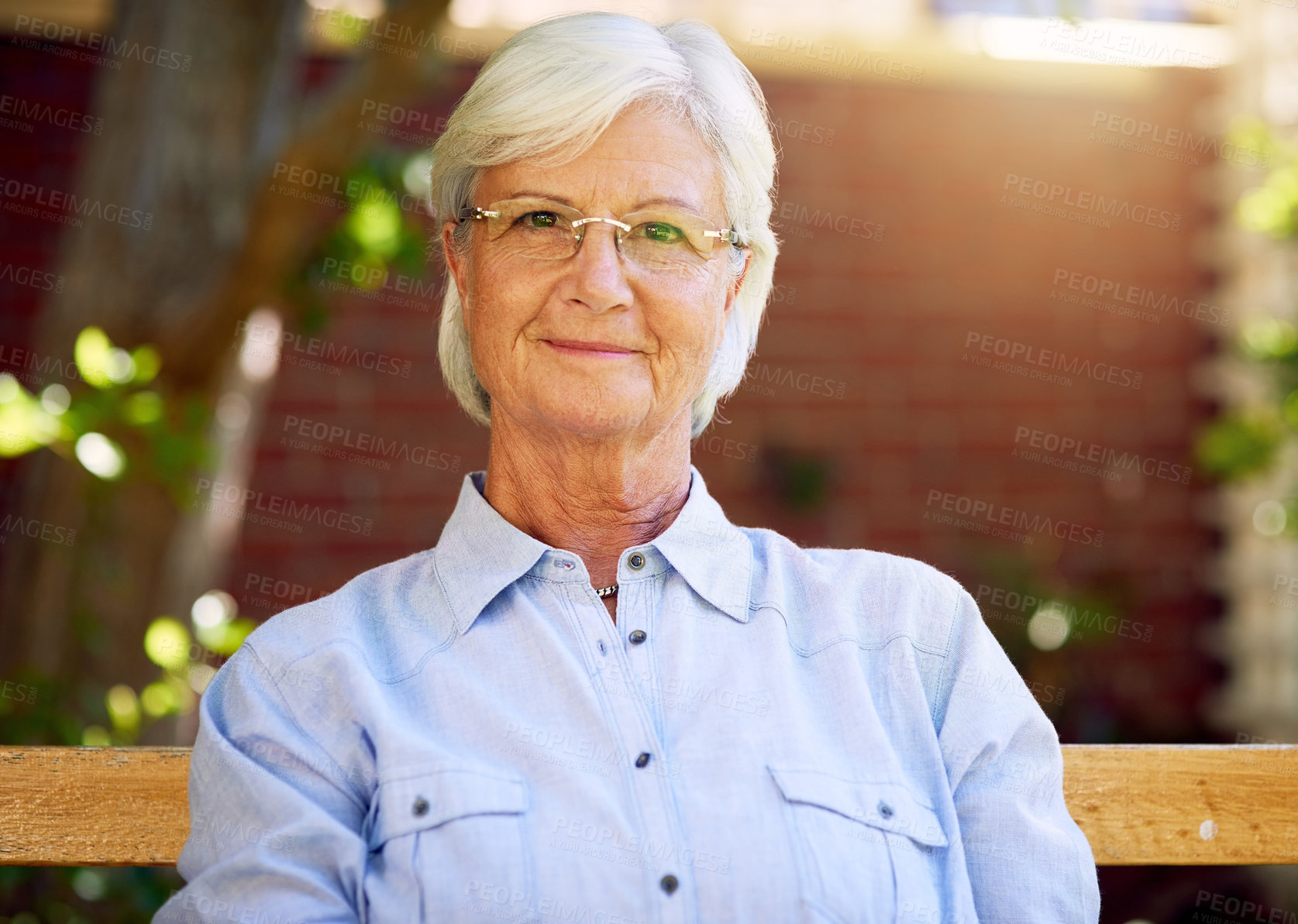 Buy stock photo Woman, senior and smile portrait or outside relaxing, garden bench and happy for retirement or wellness. Nursing home, elderly female person and pensioner, fresh air and break in summer in park