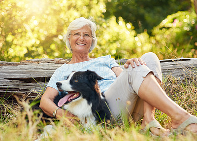 Buy stock photo Portrait of a happy senior woman relaxing in a park with her dog