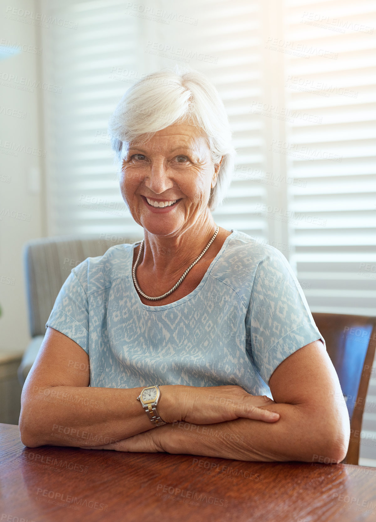 Buy stock photo Portrait, smile and senior woman in home for retirement with relax, peace and arms crossed on table. Elderly lady, happiness expression and watch in house with wellness for life goals in Australia