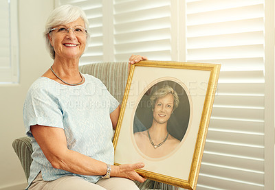 Buy stock photo Portrait of a happy senior woman posing with a portrait of herself at home