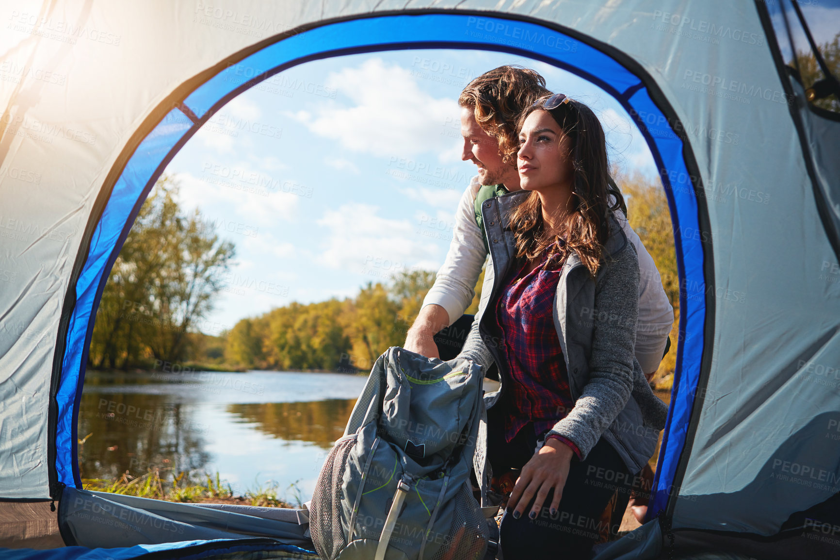 Buy stock photo Full length shot of an affectionate young couple at their campsite