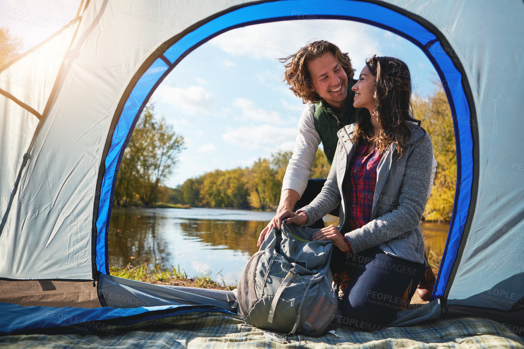 Buy stock photo Full length shot of an affectionate young couple at their campsite