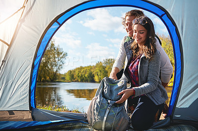 Buy stock photo Full length shot of an affectionate young couple at their campsite