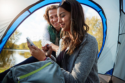 Buy stock photo Cropped shot of an affectionate young couple at their campsite