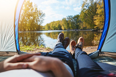 Buy stock photo Cropped shot of an unrecognizable couple lying in their tent