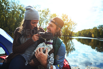 Buy stock photo Shot of a loving couple out camping with their dog