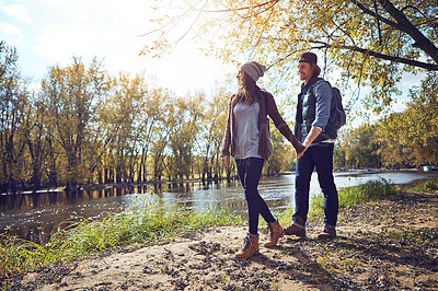 Buy stock photo Full length shot of an affectionate young couple spending a day in nature