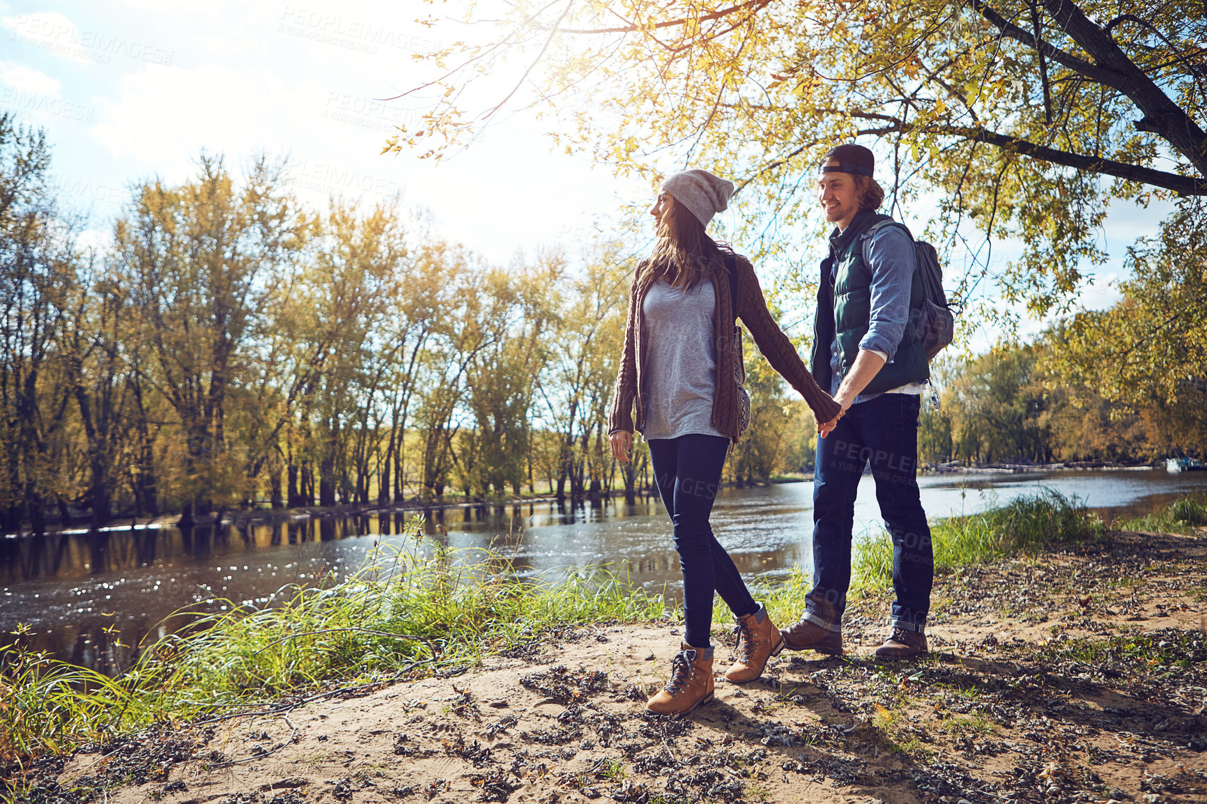 Buy stock photo Full length shot of an affectionate young couple spending a day in nature