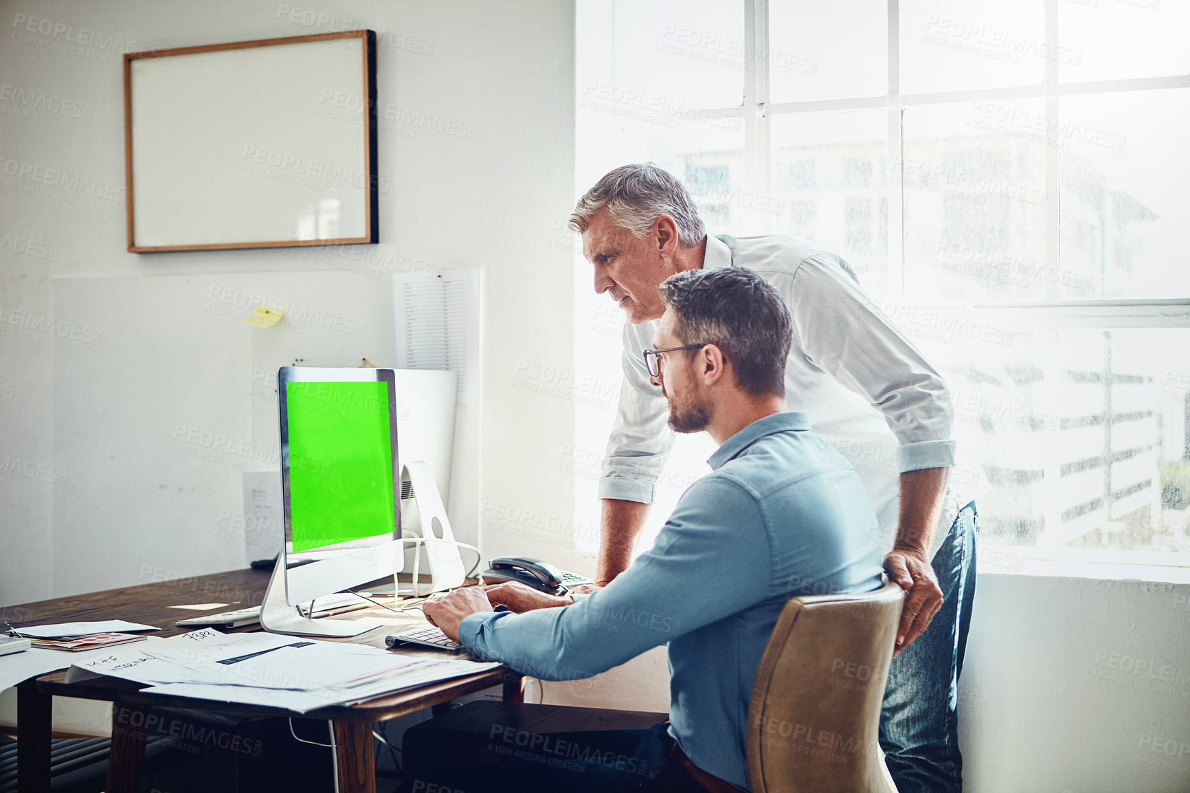 Buy stock photo Cropped shot of a mature businessman getting assistance from a colleague in the office