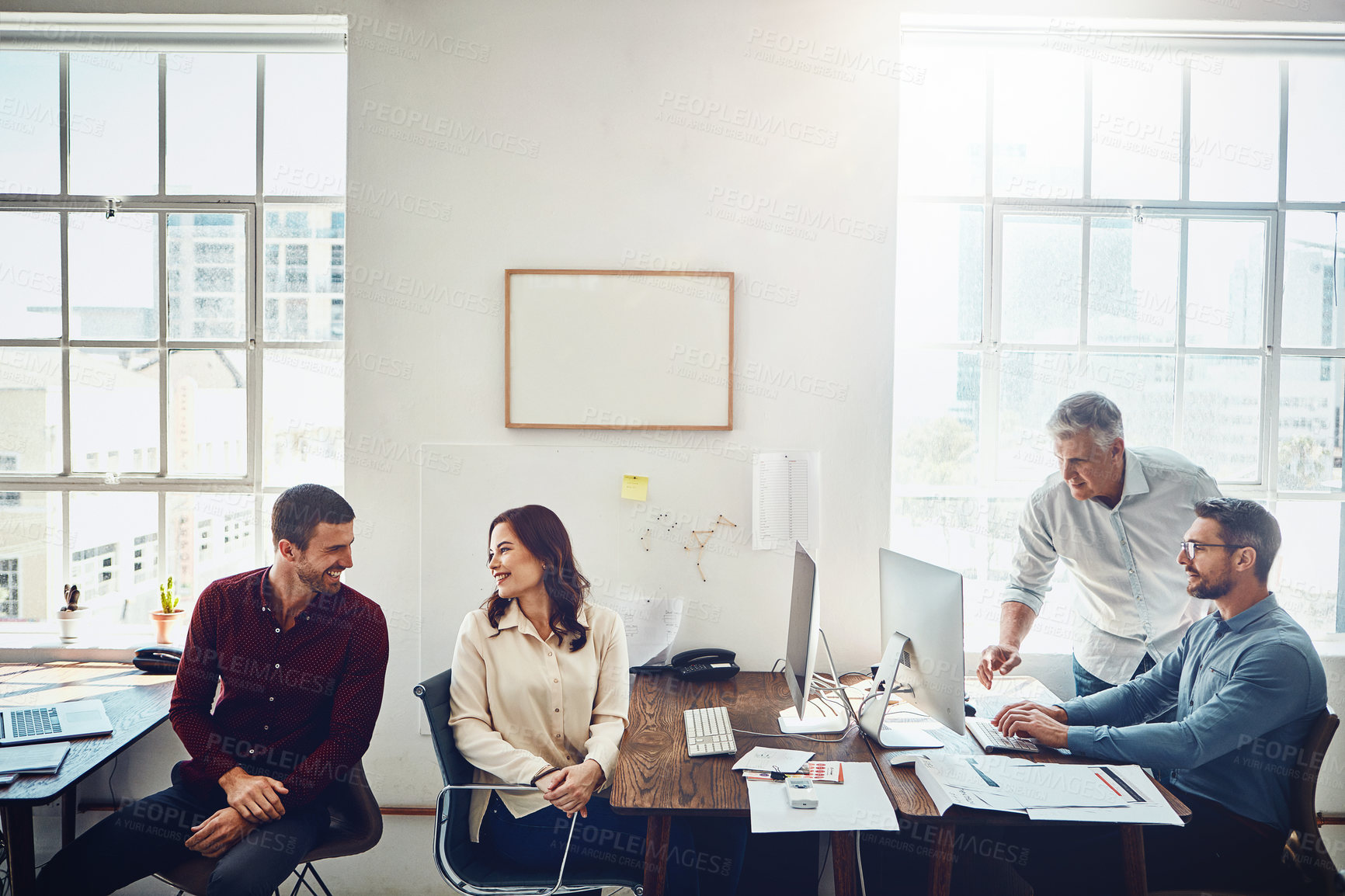 Buy stock photo Cropped shot of a group of colleagues working in their creative office